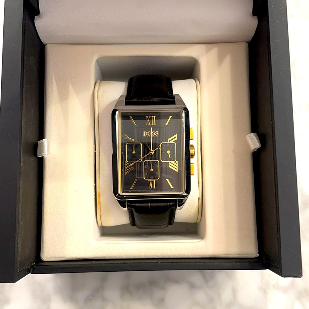 Hugo Boss watch with leather band, stainless casing with gold accents.